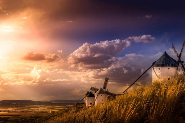 A row of mills standing on a hill