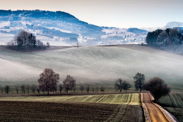 Fields and hills of Italy. Landscapes of Italy. The city is in a fog