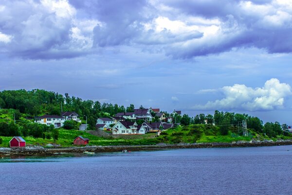 Norwegian hills with small houses on the background of the bay