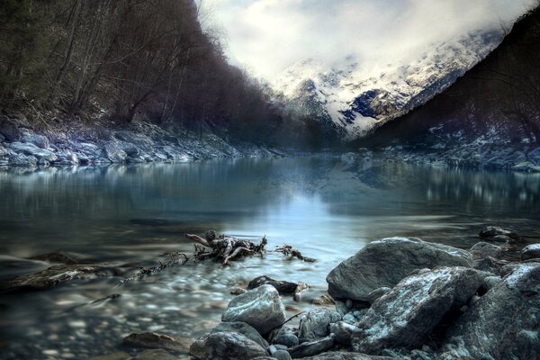 Stones near the water near the mountains