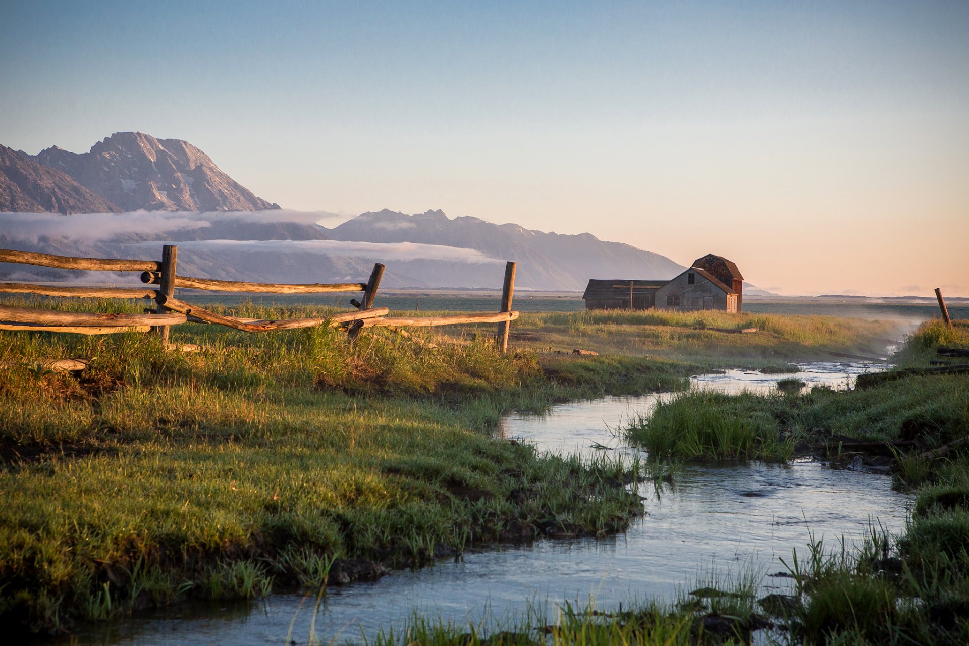 mountain sky fog house creek grass fence sunset