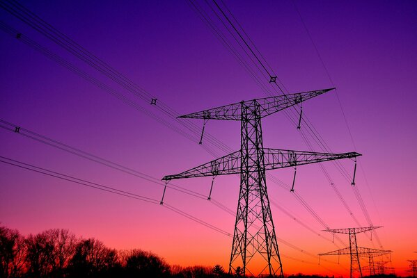 Towers connecting wires at evening sunset