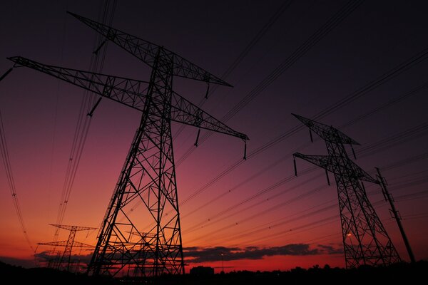 Pink sunset on the background of power poles