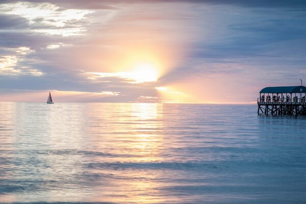 Sunset on the ocean with a pier