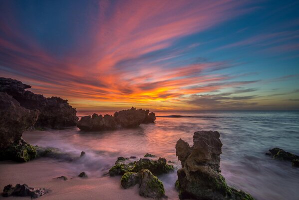 Coastal oceanic rocks on the background of a scarlet sunset