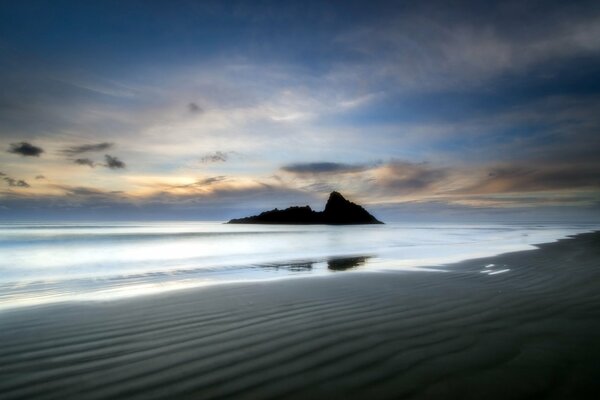 The visible part of the rock in the sea