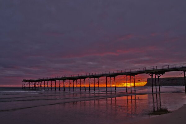 Bright red sunset on the background of the sea