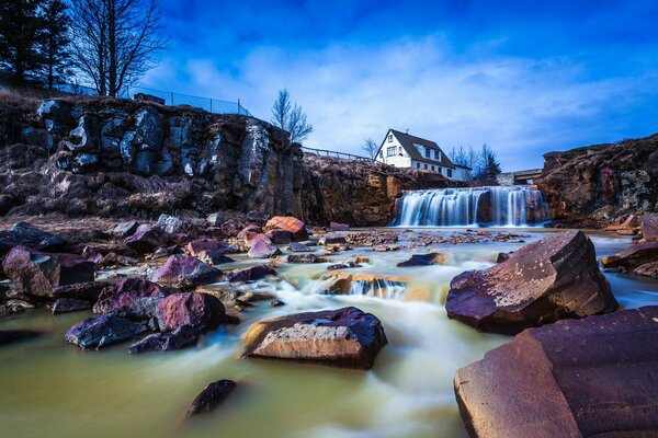 A lonely house on a mountain, around a stone lake