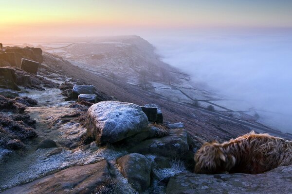 Mountains in the fog with the setting sun