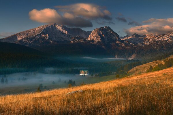 A lost house in the fog among the mountains