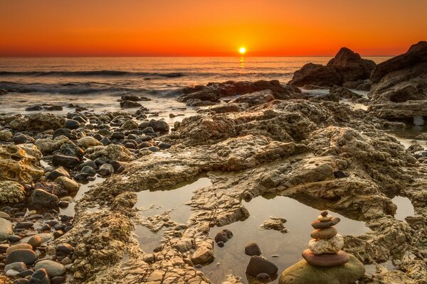 The sun waves and rocks in the sea