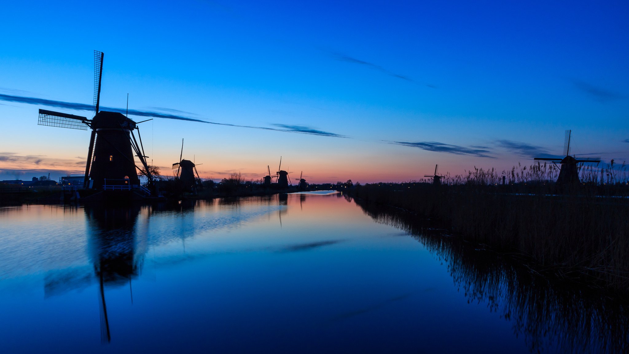 paesi bassi mulini sera tramonto cielo nuvole fiume acqua superficie liscia riflessione