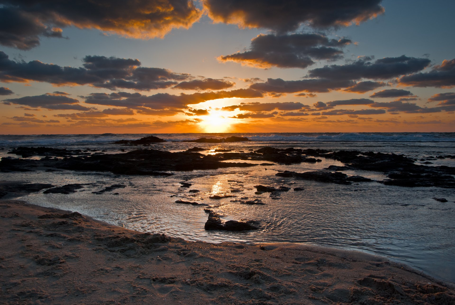 unset sea waves beach stones sky cloud