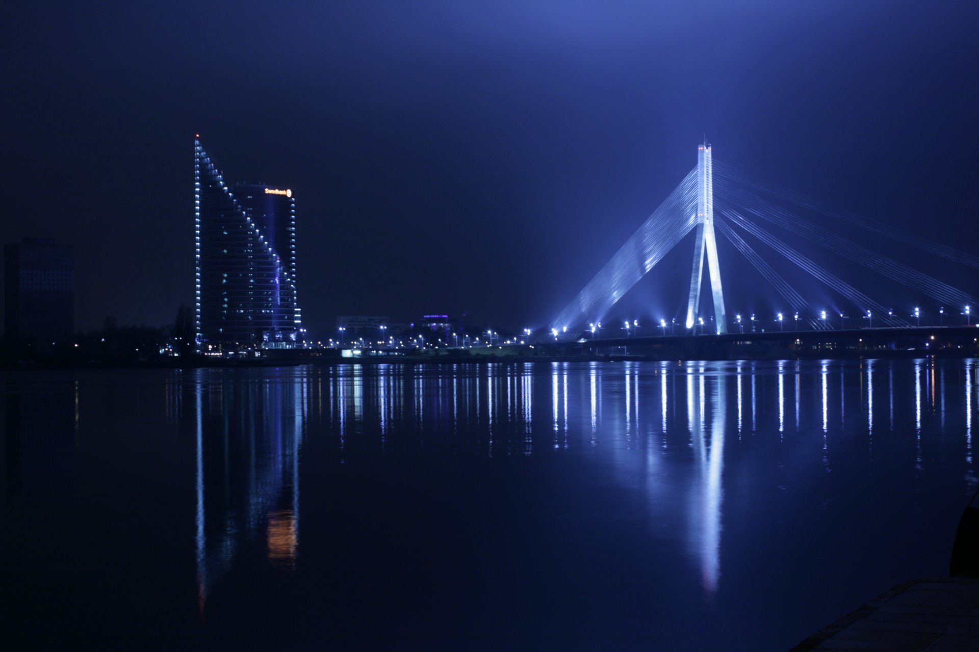 riga bridge night staro riga lanterns water