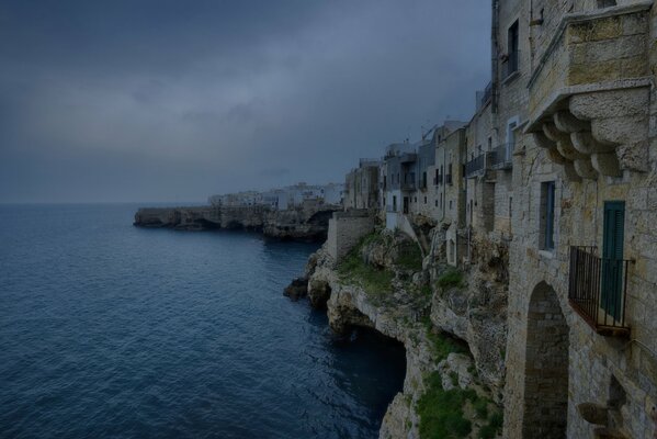 Italian mountain landscape on the background of the sea and dark sky