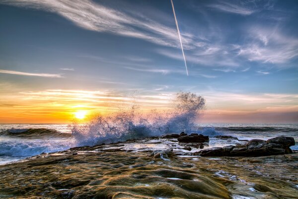 Landscape sea shore with waves at sunset