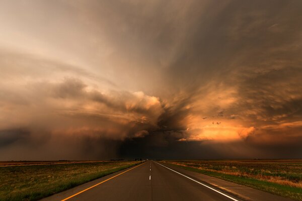 Dark storm clouds over the road