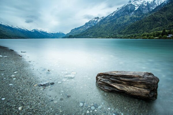 Stone on the lake shore before bad weather