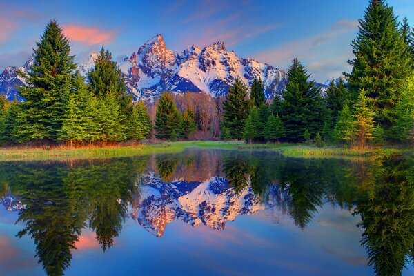 Reflection of trees and mountains in the water