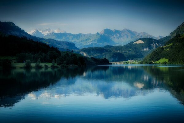 Calm mirror of the lake on the background of mountains