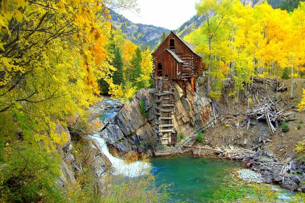 Mill on the rocks, among the woods by the river in the USA