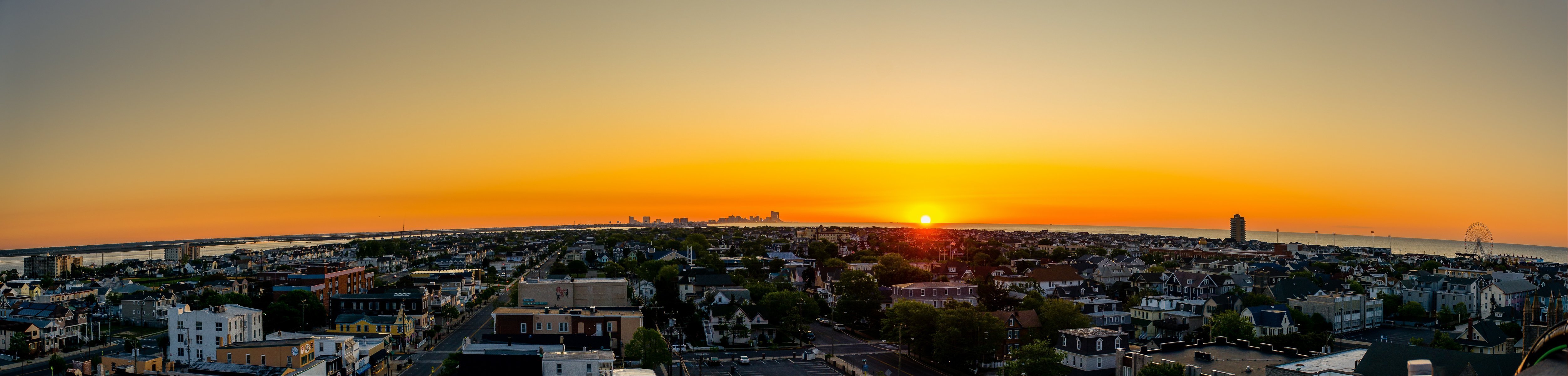 city evening sunset sky clouds sun sea water houses building