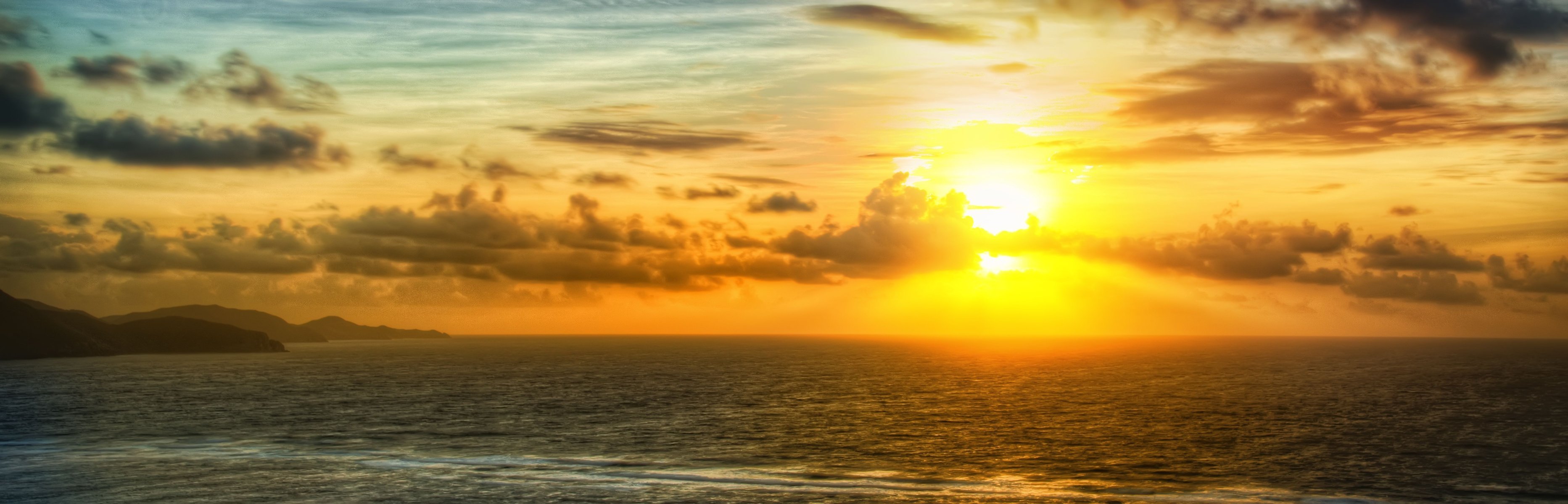 mar rocas sol cielo nubes