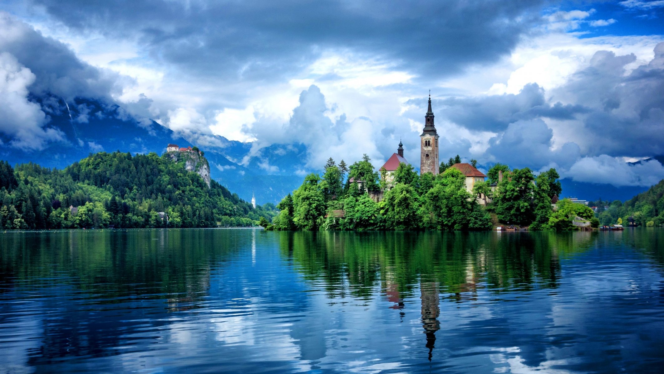 lake buildings reflection mountain tree sky cloud