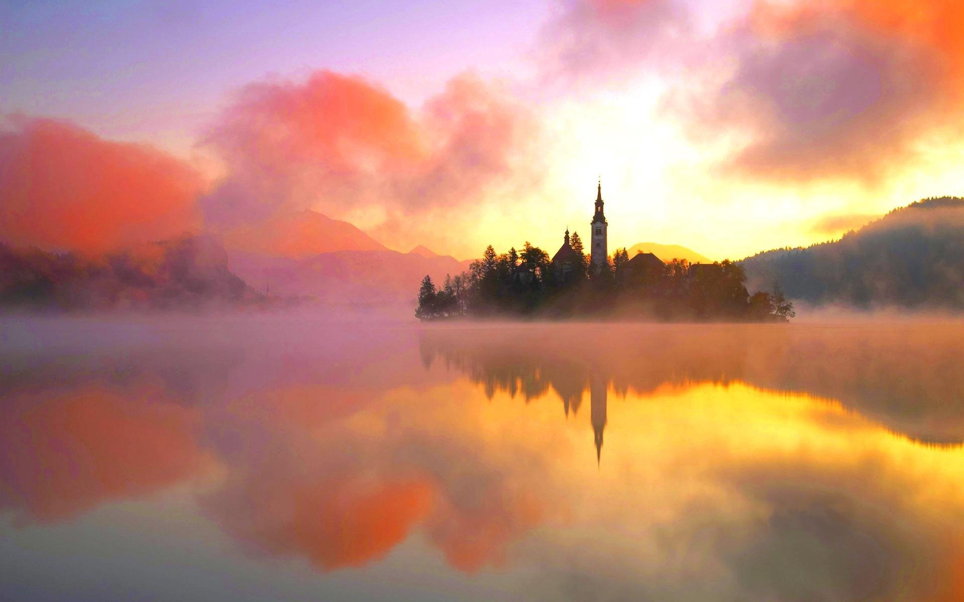 lake lake bled water island orange heat fog tower landscape nature beauty