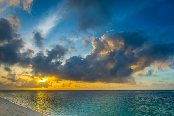 Ocean shore against the background of the setting sun