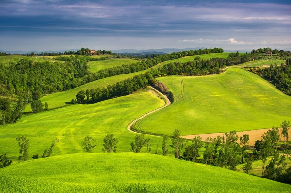 Road and hills in Italy, Tuscany, mountains and sky on the horizon