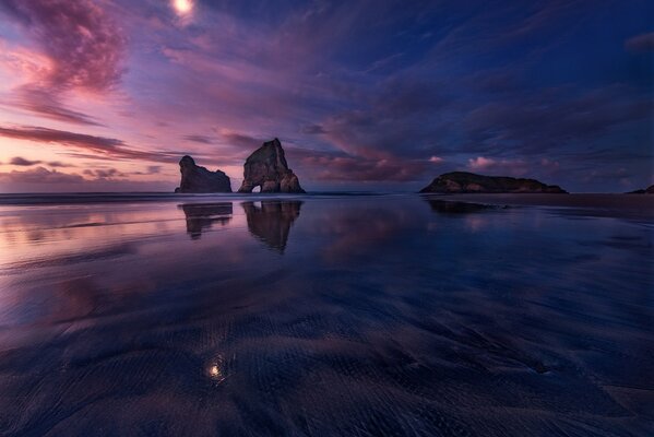 Reflection of rocks and sunset in the water