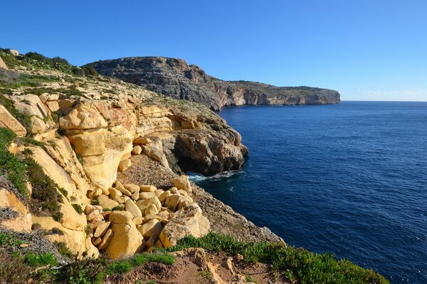 Rocks on the shore of the blue sea