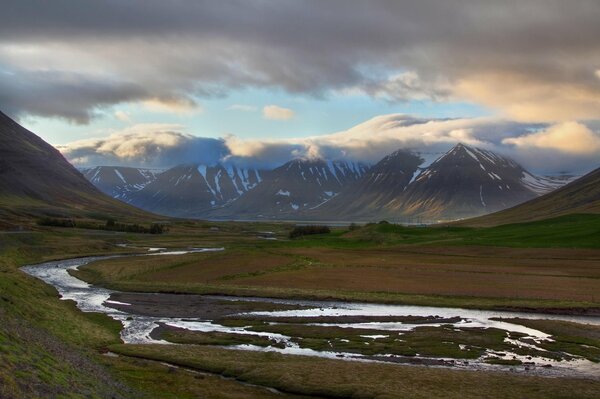 Valley and mountains in fog and clouds