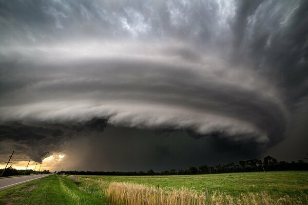 A thunderstorm vortex over a green field