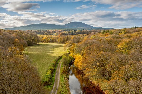 Autumn road along the river