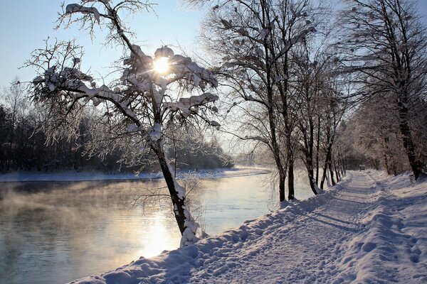 Winter road along the river bank