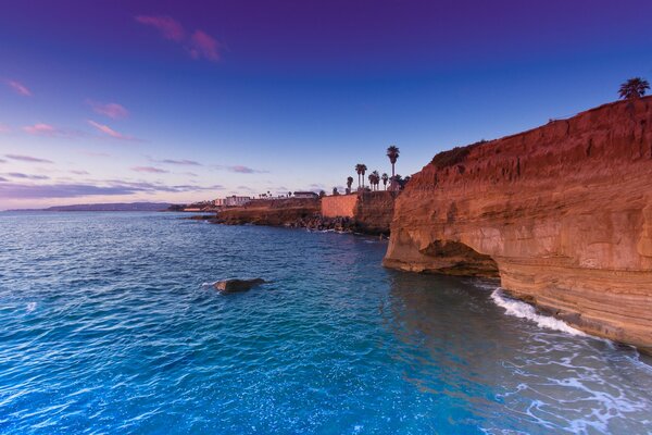 Sea sunset on the background of mountain rocks