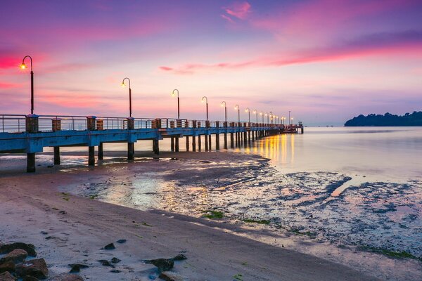 Sunset at the bridge in the sea