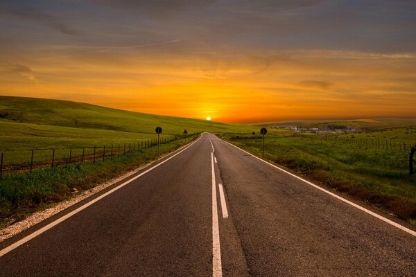 Paved road going into the sunset