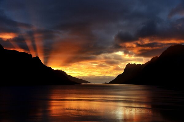 Sunset with clouds. Mirror Bay between the mountains