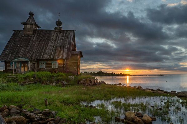 An old wooden church next to the water