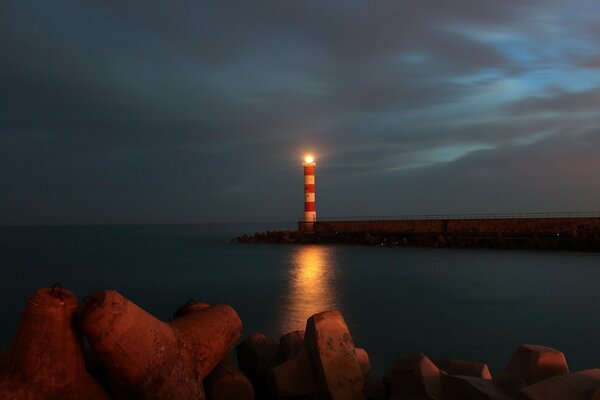 View of the glowing lighthouse at dusk