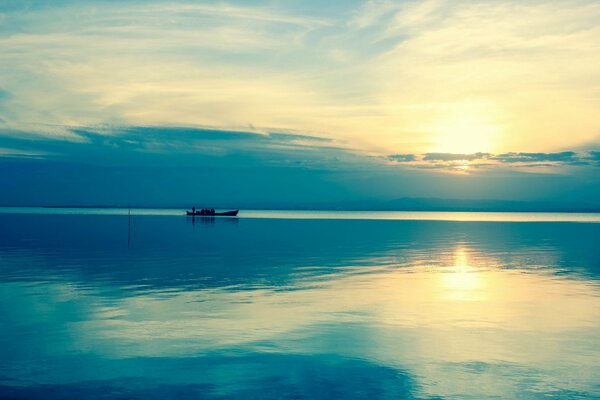 The sky is azure. The boat is floating on the sea