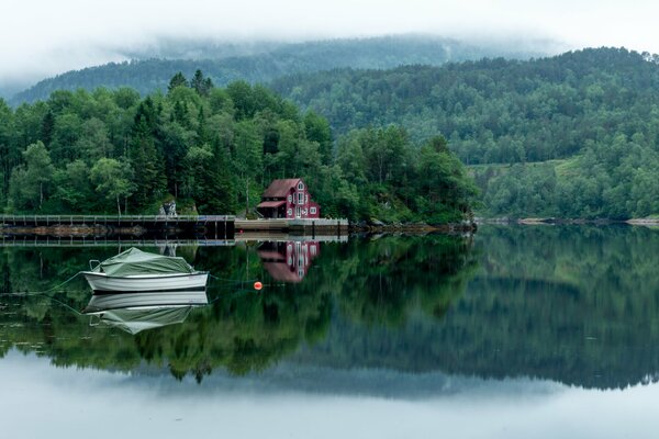 Landscape with a forest lake and a boat