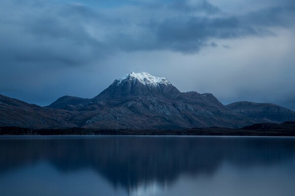 Snow on top of a mountain by the sea