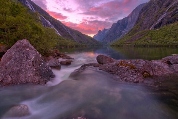 Ein außergewöhnlicher See in Norwegen. Berge, die den Sonnenuntergang bedecken