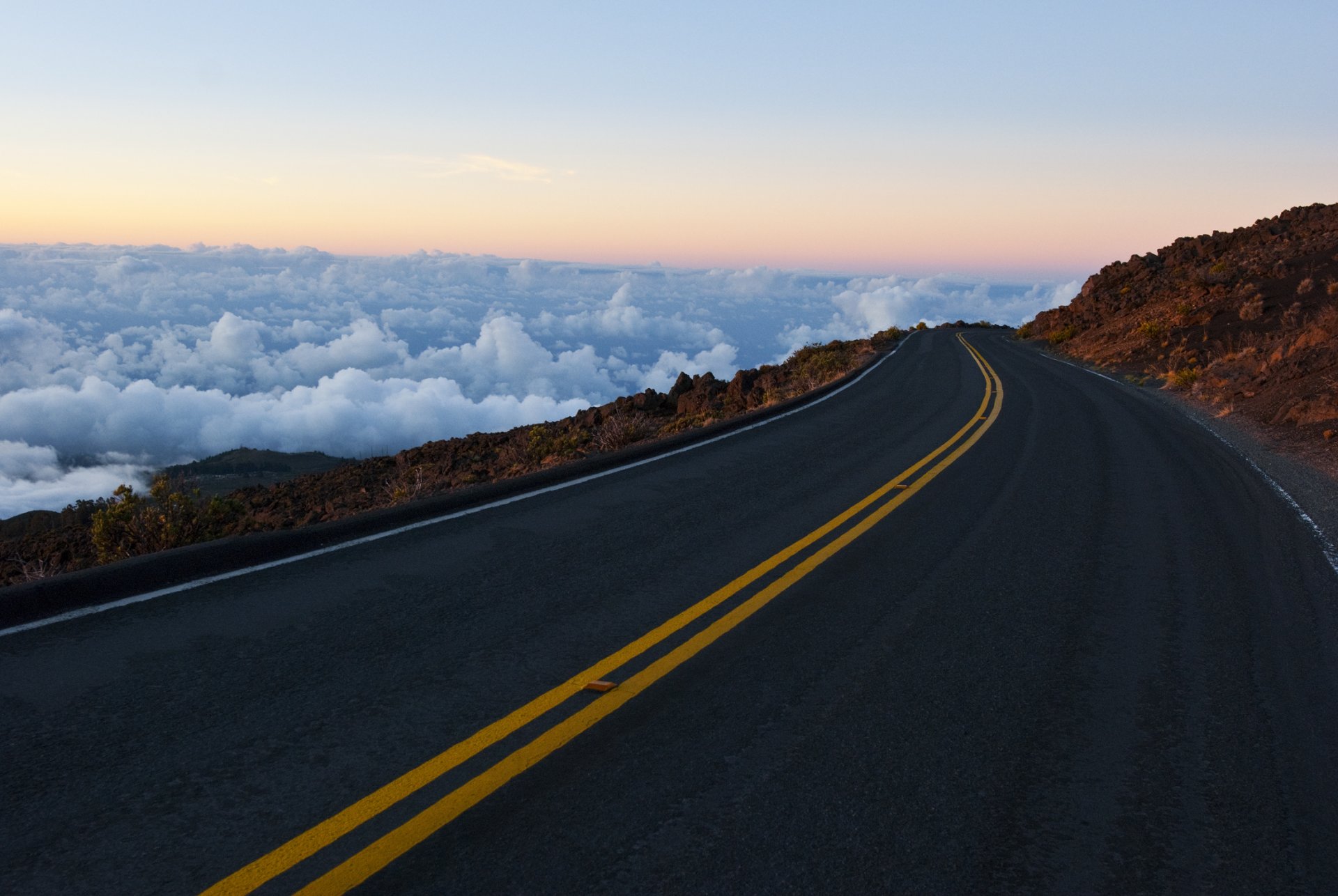 road counting mountain rock sky clouds horizon