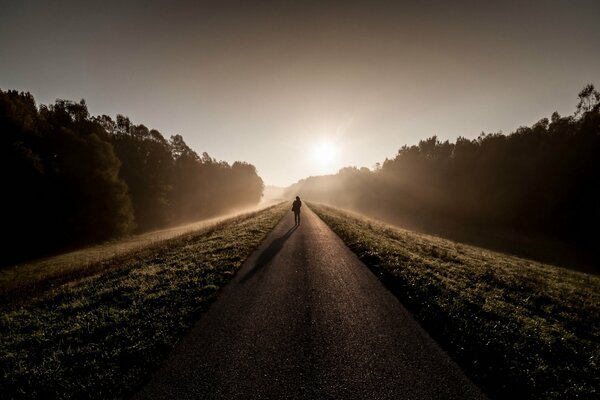 Picture of a man in the morning on the road in the fog