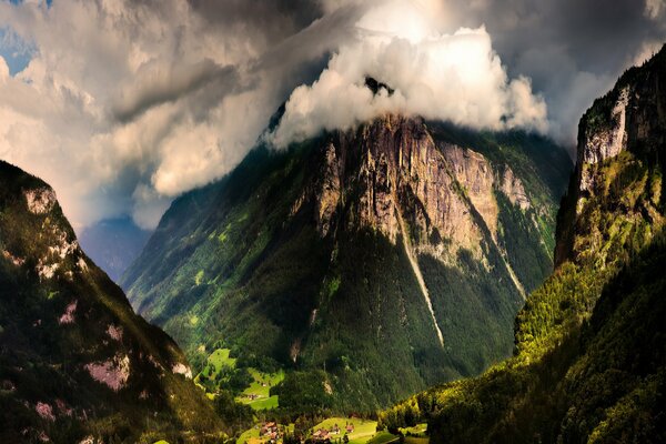 Die Berge sind mit Sonne in den Wolken überflutet